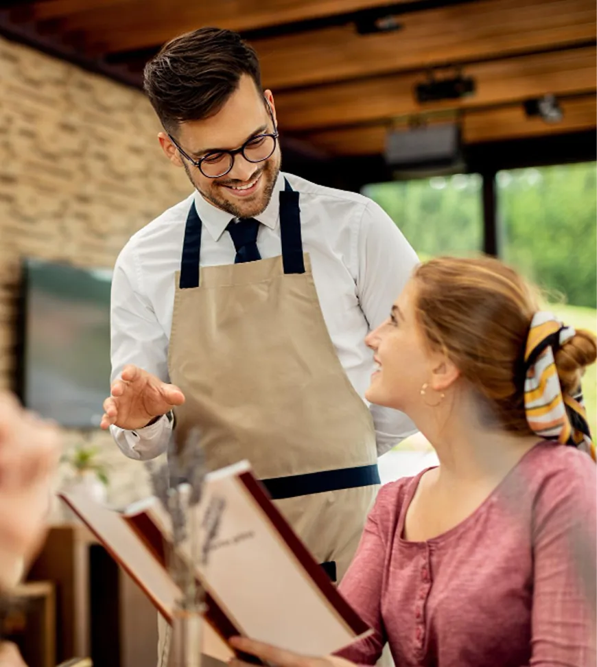 Server speaking with a guest after a meal